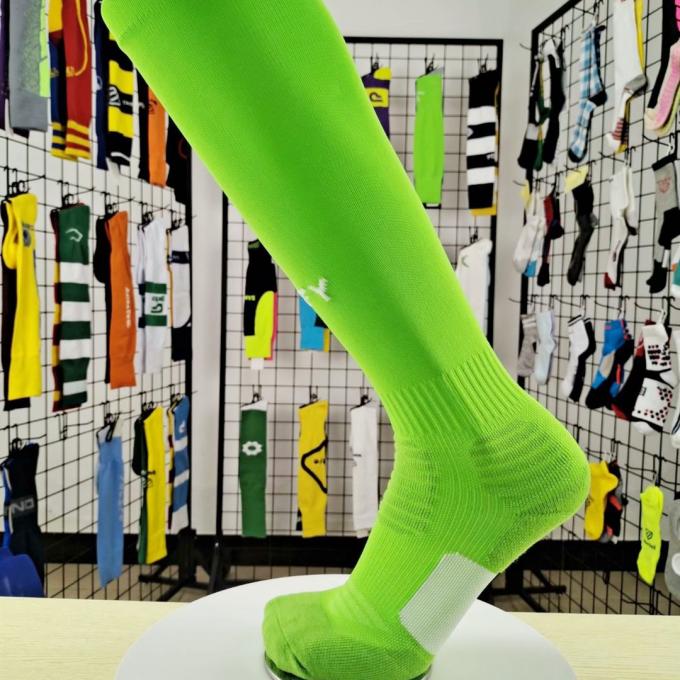 El deporte de encargo al por mayor del logotipo del OEM pega calcetines verdes del fútbol del fluor anti del resbalón
